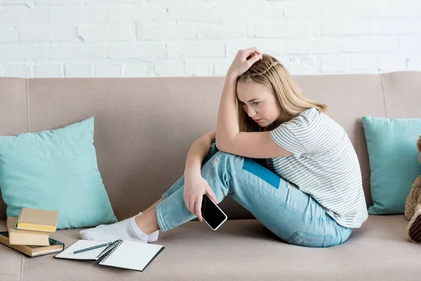 Depressed Teen Girl Sitting Couch Smartphone While Doing Homework — стоковое фото