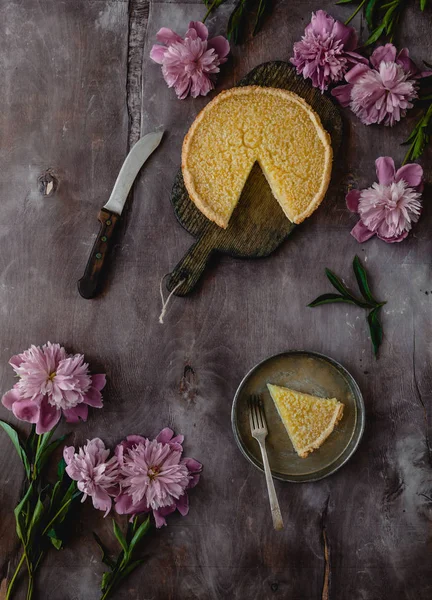 Top View Tasty Lemon Pie Wooden Table Purple Peonies — стоковое фото