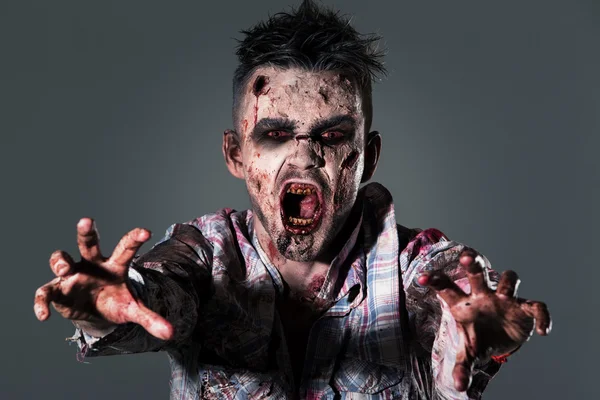 Aggressive, creepy zombie in clothes — стоковое фото