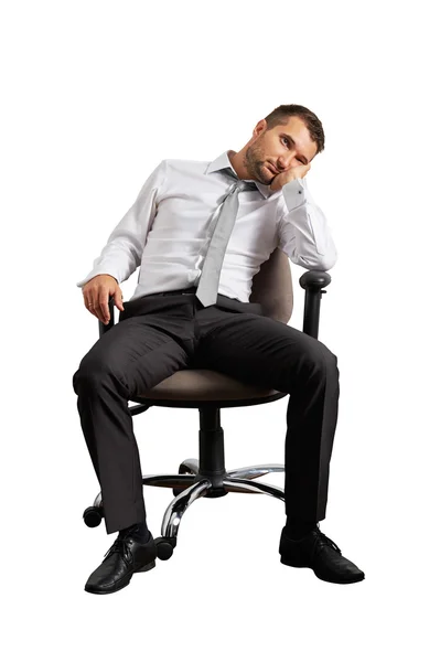 Скучно бизнесмен, сидя на офисный стул Стоковое Фото