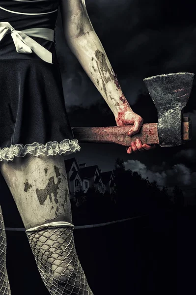 Evil woman holding a bloody ax — стоковое фото