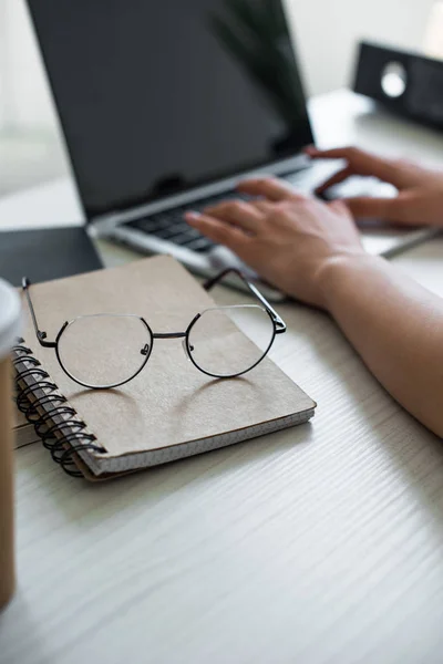 Close View Eyeglasses Notebook Person Using Laptop — стоковое фото