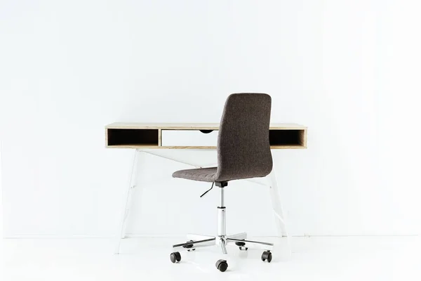 Stylish Empty Work Table Wheeled Chair Front White Wall Лицензионные Стоковые Фото