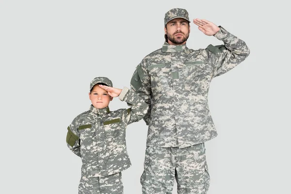 Portrait Confident Soldier Son Military Uniforms Saluting Isolated Grey — стоковое фото
