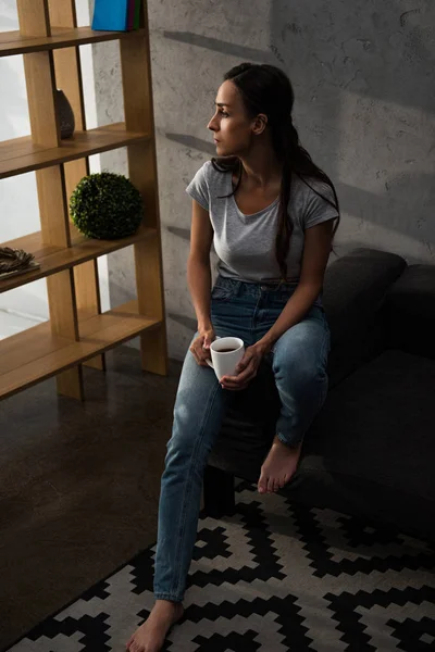 Upset Woman Cup Coffee Sitting Sofa — стоковое фото