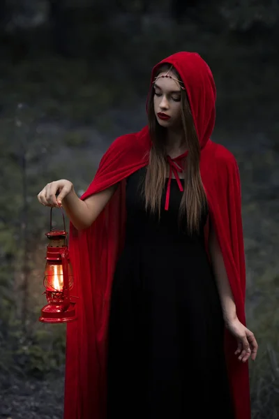 Beautiful Mystic Girl Red Cloak Walking Dark Forest Kerosene Lamp — стоковое фото