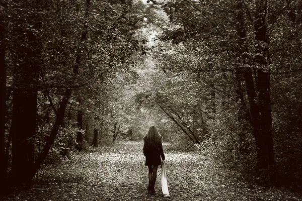 Lonely sad woman on the wood road — стоковое фото
